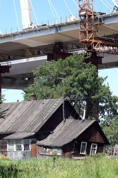 Ponte de cabo-permanecido em construção sobre casa residencial, dia ensolarado de verão . — Fotografia de Stock