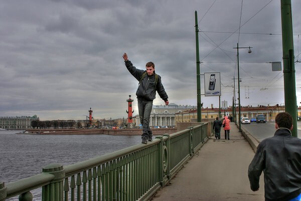 Young man makes life threatening walk on parapet of bridge.