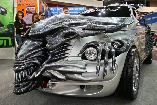 Car tuning style alien at Motor Show. Stock Photo
