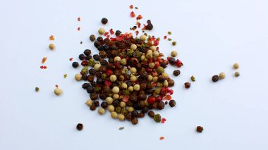 Allspice beans. Colored grains of pepper. Seasoning. On white background. clipart