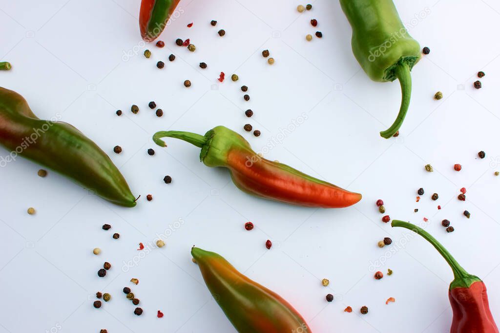 Allspice beans. Colored grains of pepper. Seasoning. A pod of hot red unripe pepper. On white background.