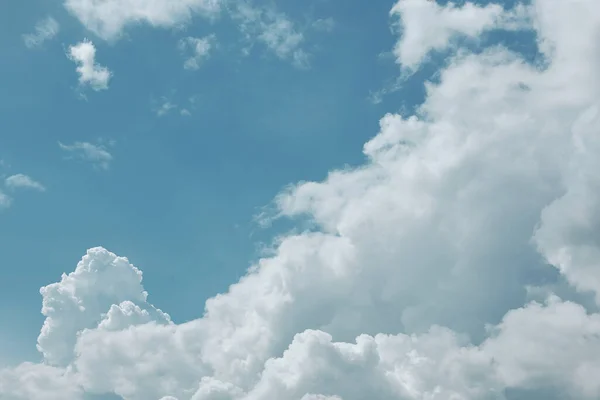 Gentle blue sky with airy white and gray clouds. Photo for background or wallpaper.