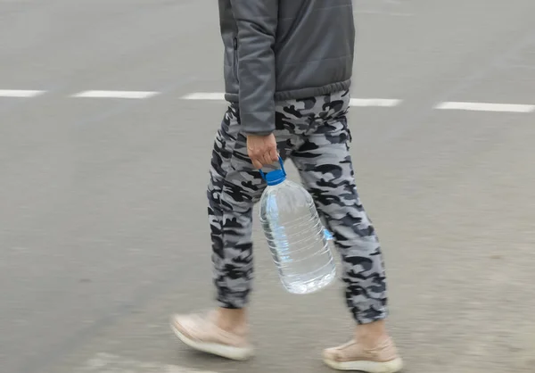 Een Man Met Een Grote Fles Water Steekt Straat — Stockfoto