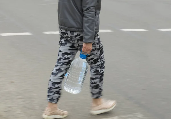 Een Man Met Een Grote Fles Water Steekt Straat — Stockfoto