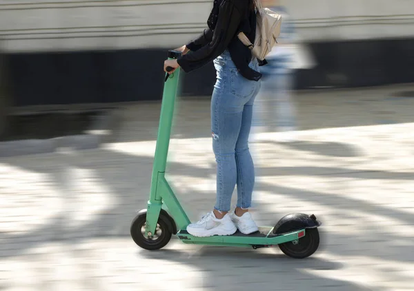 Objects in motion, girl on electric scooter