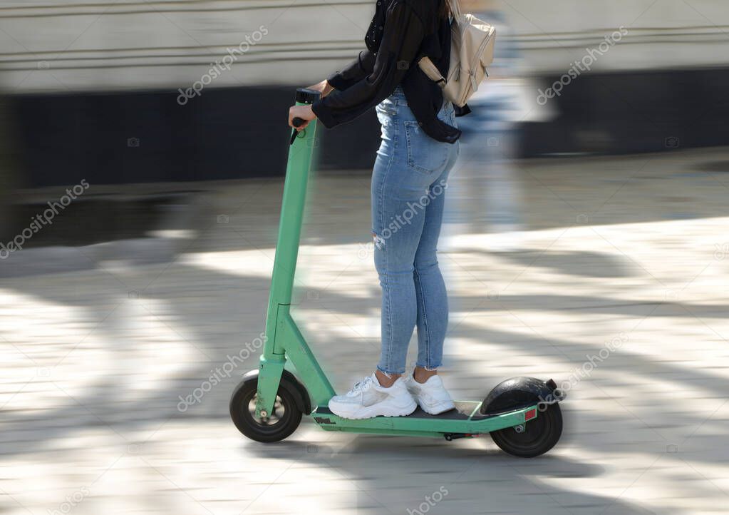 Objects in motion, girl on electric scooter 