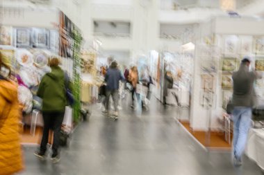 Abstract image of people in the lobby of a shopping center with a blurred background