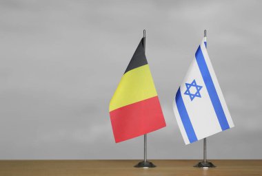 Belçika ve İsrail 'in masa üstü bayrakları gri bir arka planda duruyor