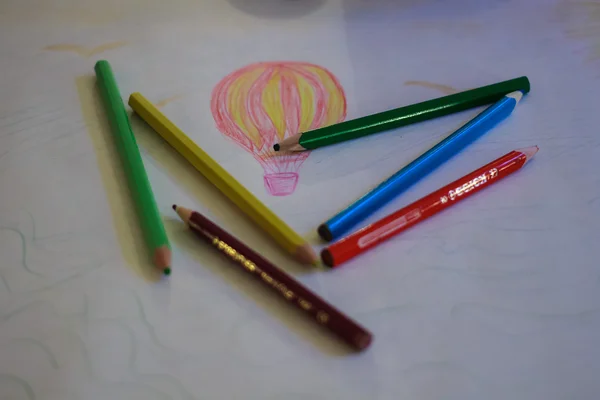 Pencils on a child's drawing of the balloon — Stock Photo, Image