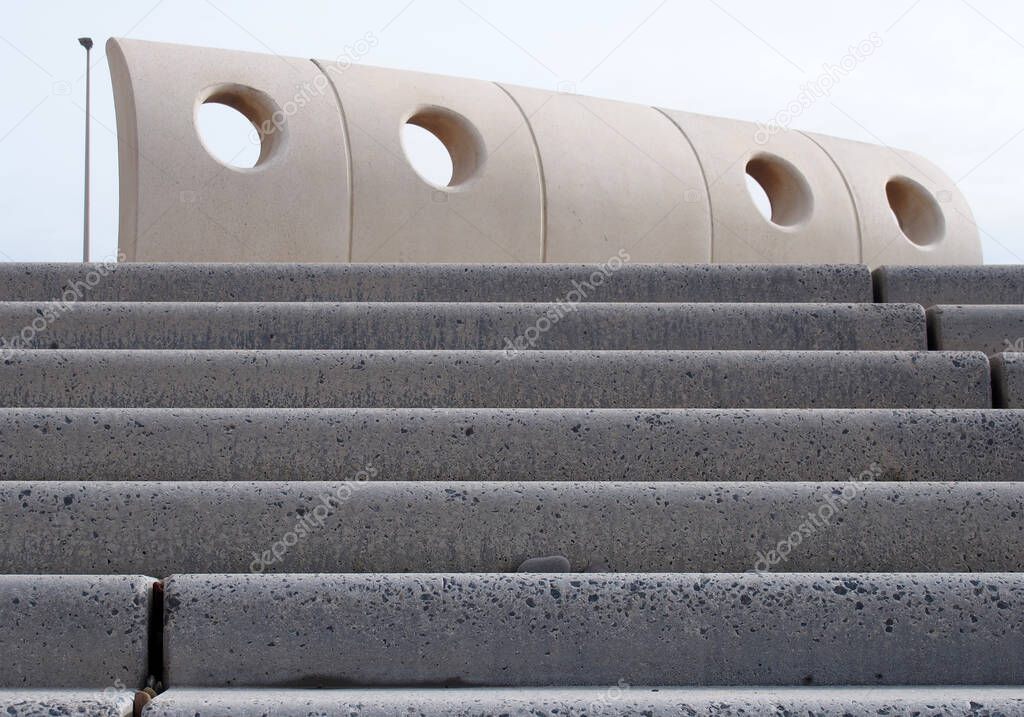 grey textured outdoor concrete stairs with geometric curved wind shelter in Cleveleys, Lancashire