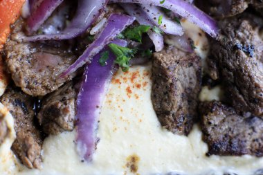 Kremalı Humus Macro Shot ile servis edilen gurme biftek.