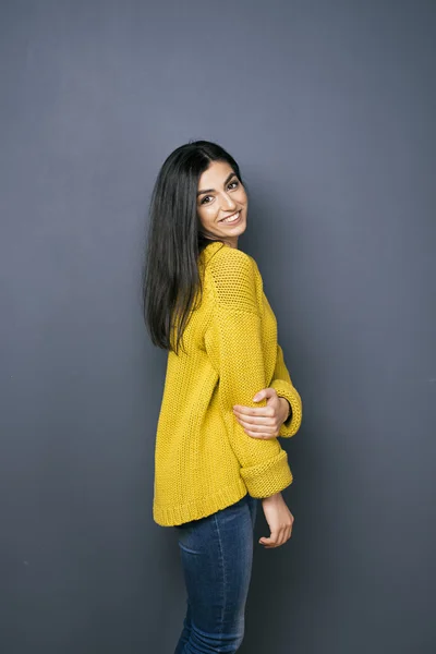 Side view of beautiful smiling girl against of grey background — Stock Photo, Image