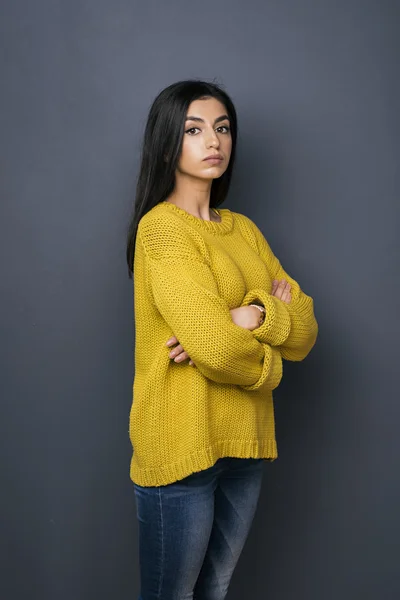 Portrait of serious Armenian girl in yellow sweater — Stock Photo, Image