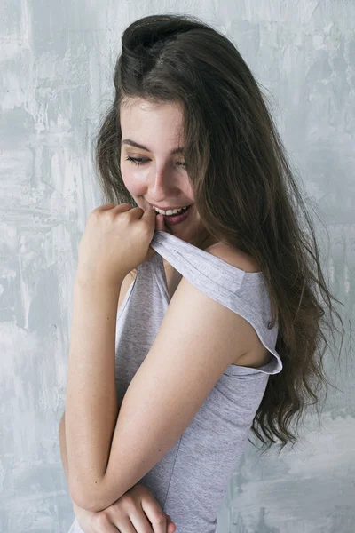 Side view of playful young girl pulling top strap up — Stock Photo, Image