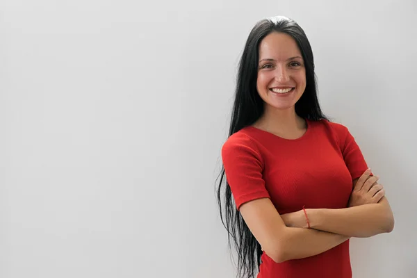 Successful woman in red dress smiling at camera — Stock Photo, Image