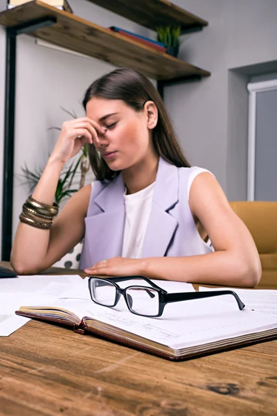 Stressed young businesswoman at office table — Stock Photo, Image