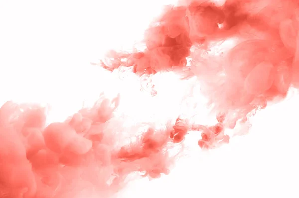 Coral ink splashes abstrct background. Studio shot with seamless watercolor swirls in the water