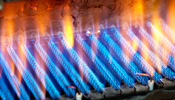 The fire burns from a gas burner. Blue flame when burning gas.