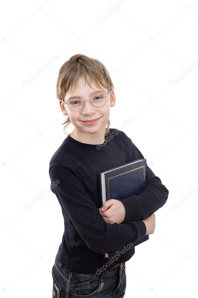 A boy aged 11 years, holding a book.