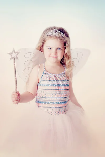 Smiling little girl with magic wand — Stock Photo, Image