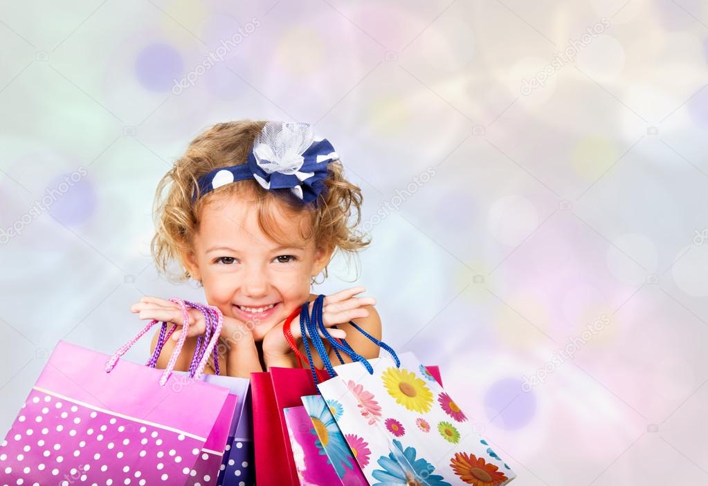 Joyful girl with bags of shopping