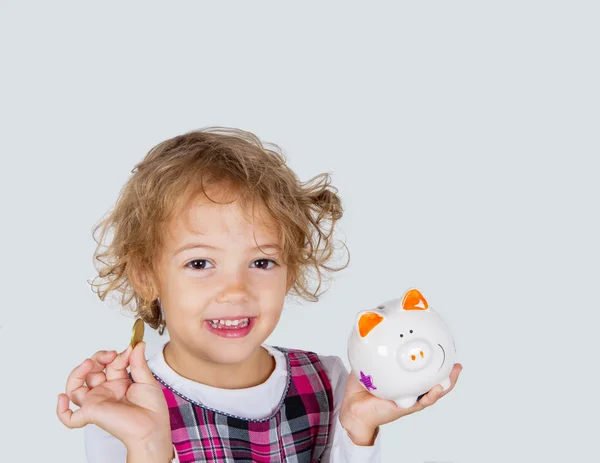 Menina com banco porquinho — Fotografia de Stock