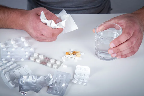 Man with glass of water and tablets — Stock Photo, Image