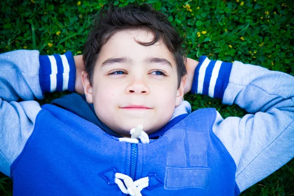 Boy dreaming on the lawn — Stock Photo, Image