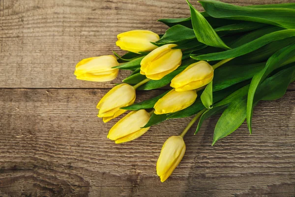 Yellow tulips on the wood — Stock Photo, Image