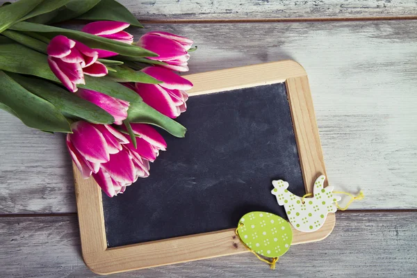 Blackboard with pink tulips — Stock Photo, Image