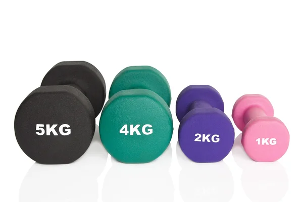 Black, green, pink and purple dumbbells — Stock Photo, Image