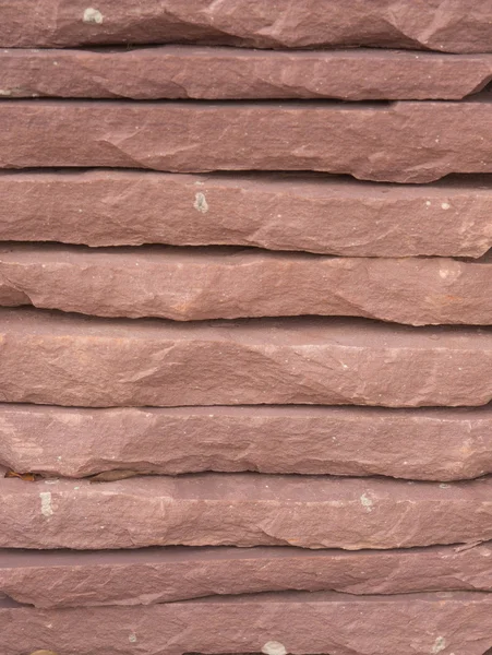 Een gestapelde stenen muur achtergrond textuur — Stockfoto