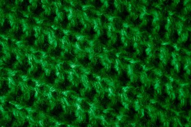 İlginç bir deseni olan yeşil yün bir madde.
