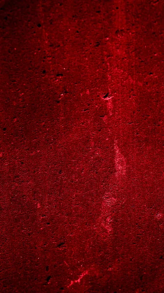 İlginç bir deseni olan kırmızı boyayla boyanmış duvar.