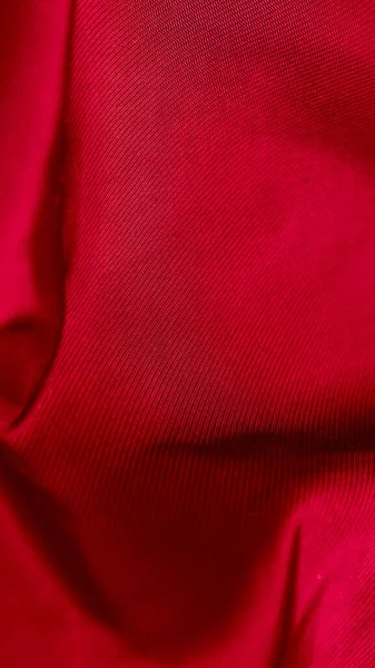 Czerwony Marszczony bawelniany materyali z widocznymi szzegolami. tlo