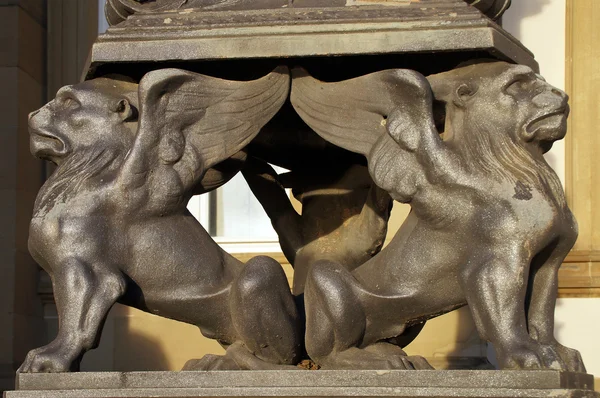 Two griffins form the foot of a magnificent candelabra — Stock Photo, Image