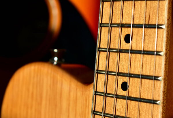 Electric guitar background. Maple fretboard and swamp ash body close-up.