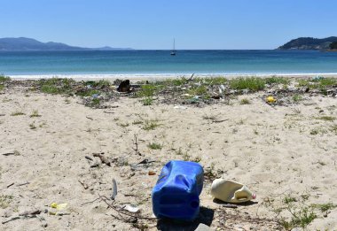 Beach with plastic pollution on sand at famous Rias Baixas Region. Corua Province, Galicia, Spain.