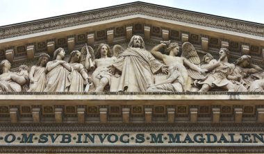Frieze close-up at Church of La Madeleine. Last Judgment with Jesus Christ, Mary Magdalene, Angels and Archangels. Paris, France. 