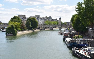 Paris, France. August 17, 2018. View of Seine River, Pont Neuf, Ile de la Cite and Square du Vert-Galant from Pont des Arts.