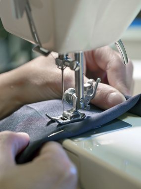hand of  woman working with old sewing machine