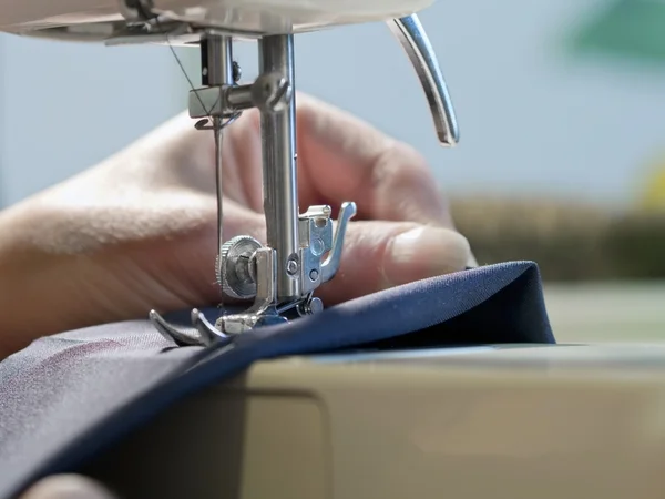 Hand of  woman working  with  old sewing machine 图库图片