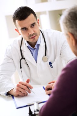 Doctor listening to patient explaining his painful