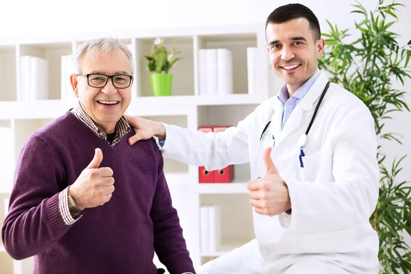 Doctor specialist and patient shows finger up — Stock Photo, Image