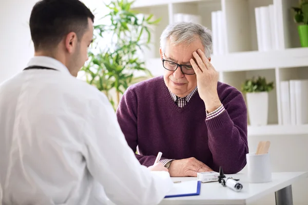 Elderly patient with pains in head need examining Stock Image