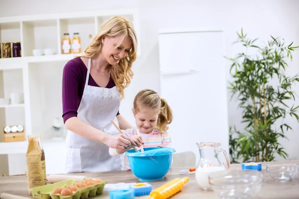 Woman and girl making homemade cookies