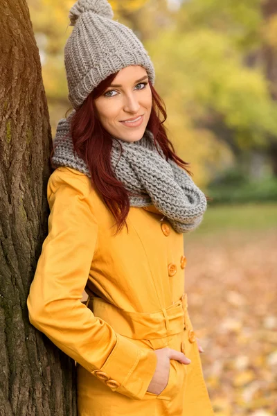 Mulher sorridente de casaco amarelo — Fotografia de Stock