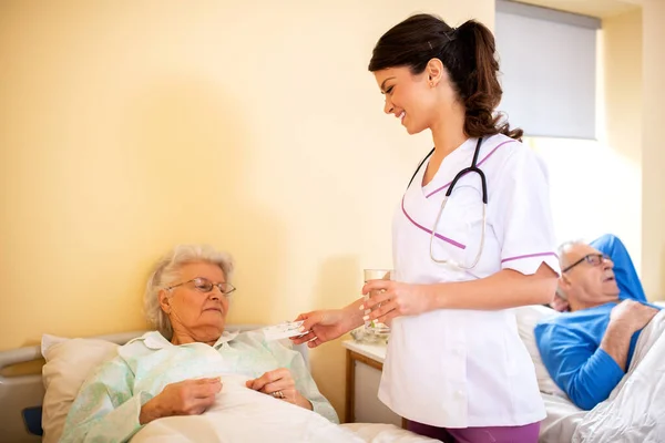 Caring Young Female Doctor Bringing Glass Water Her Patient Nursing — Stock Photo, Image