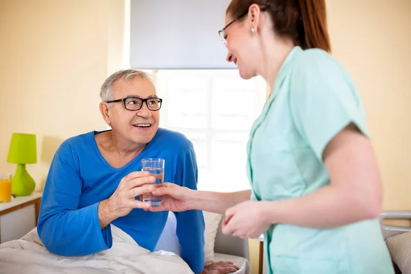 Loving Nurse Handing Glass Water Her Nursing Occupant Elder Peoples — Stock Photo, Image