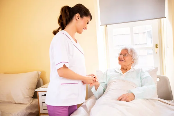 Nursing Home Doctor Holding Hand Senior Woman Patient Occupant While — Stock Photo, Image